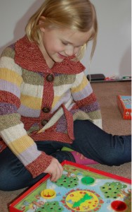 girl in striped sweater with game